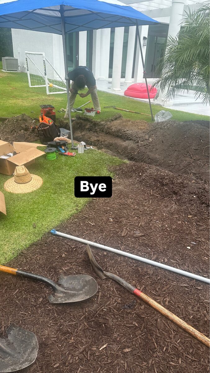 Landscape lighting underground wire installation in progress for luxury residential outdoor lighting system