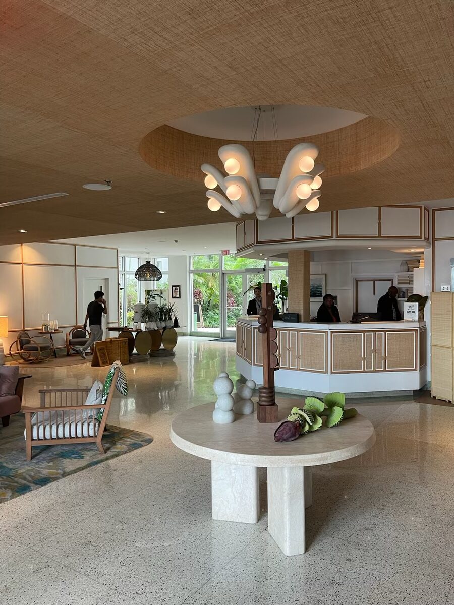 Luxury hotel lobby with custom designer chandelier installation — recessed lighting and statement pendant
