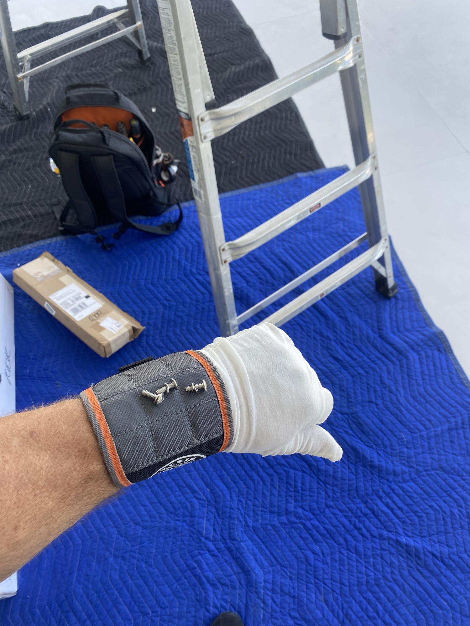 CCC technician in white cotton gloves protecting finished surfaces — drop cloths, booties, and full uniform on every job
